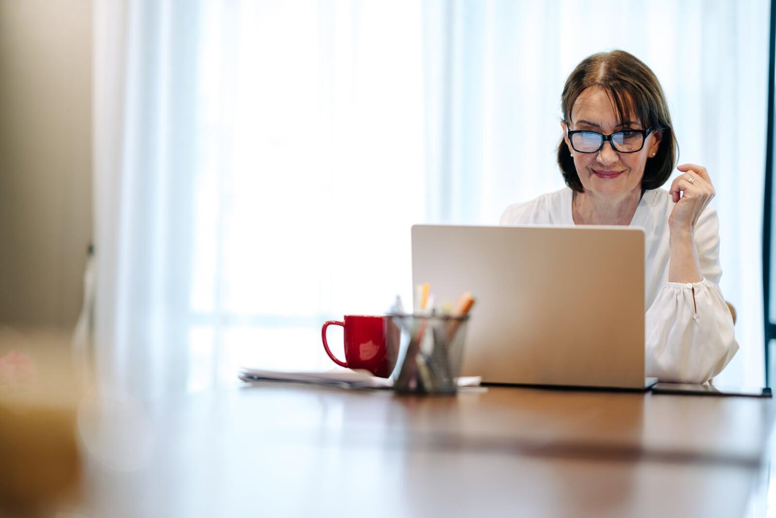 Teacher at desk in front of laptop